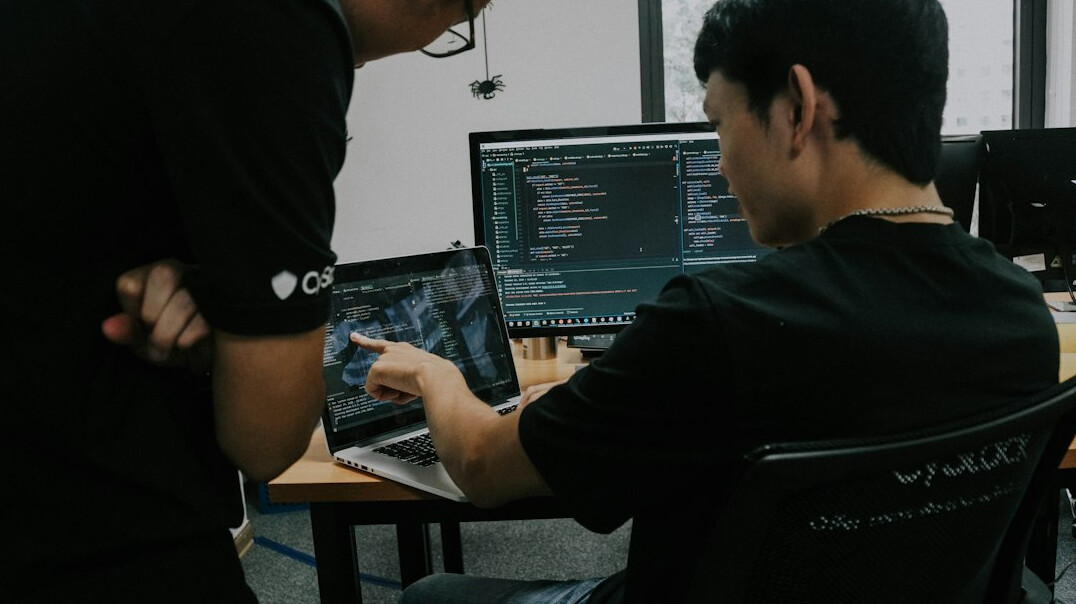 programmer coding on laptop