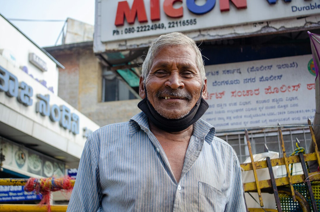 Malaysian Indian man compliance specialist smiling at camera